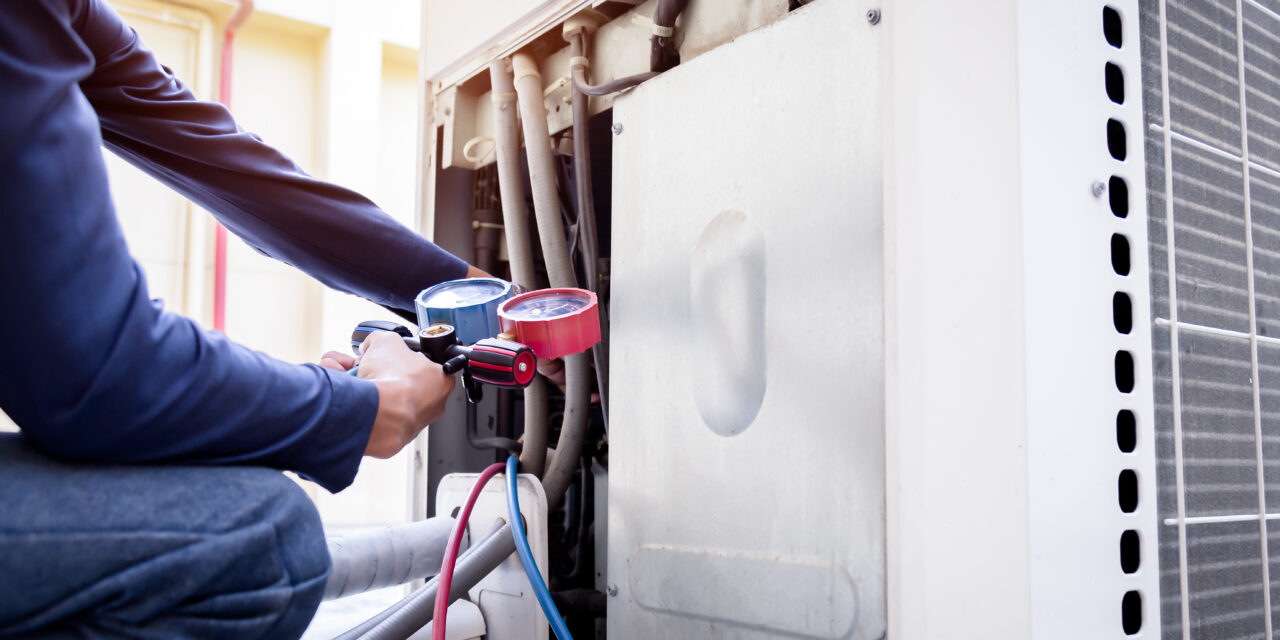 Technician is checking air conditioner ,measuring equipment for filling air conditioners.